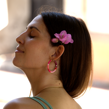 Load image into Gallery viewer, Model wearing red and pink Colombian hoops with flower in beach style